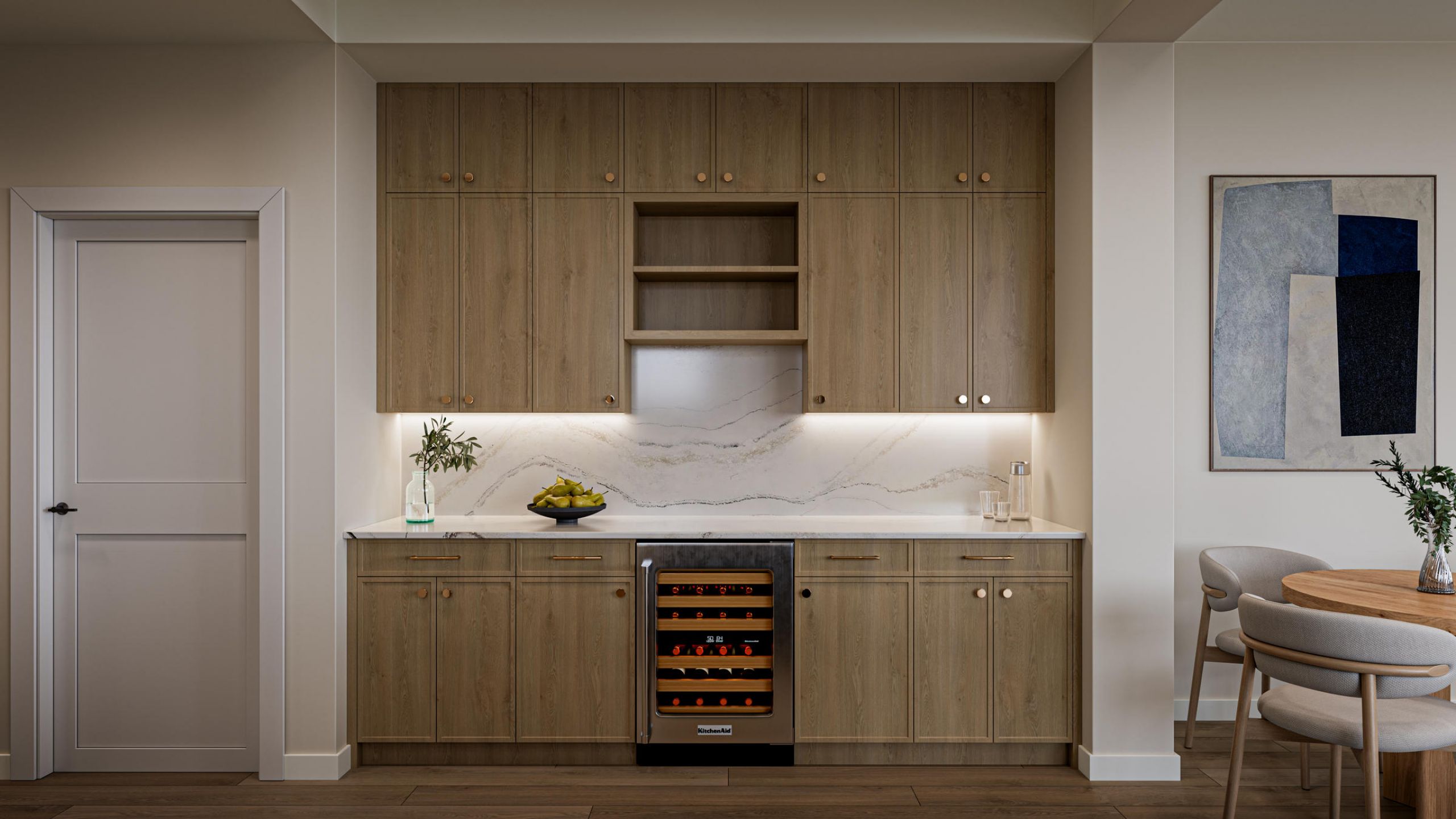 Modern kitchen with wood cabinets, marble backsplash, wine fridge, and minimal decor on a white countertop.