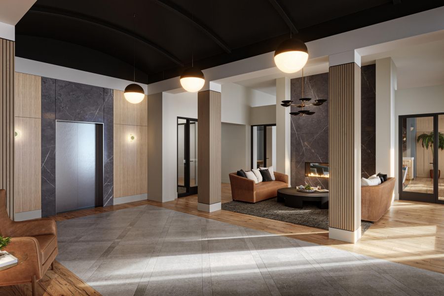 Modern lobby with wood accents, elevator, seating area, and fireplace under round ceiling lights.